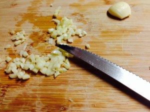 Chop garlic and saute over med-low heat in 1-2 T. of olive oil.  After a minute or two, add several handfuls of spinach and cook til wilted. 