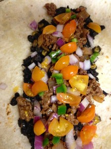 Add all your fixings to tortillas (I added some cooked black beans/corn that I had leftover and just a smidge of cheese) and roll, placing the tortillas seam-down in a baking dish.   