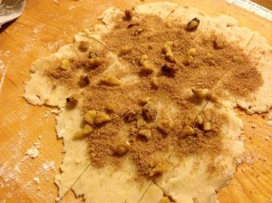 Roll out excess crust and sprinkle with cinnamon and sugar (and walnuts, if you're me and are using leftover cinnamon bun filling you found in the cupboard. Thanks mom!)